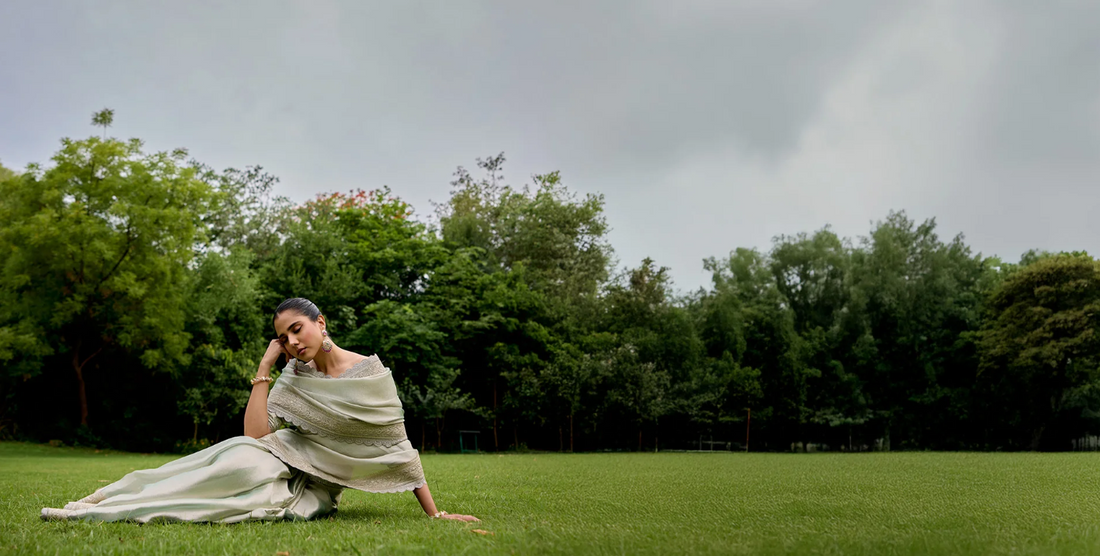 Hand-embroidered ivory crepe saree with floral zari border by Mehr by Annu