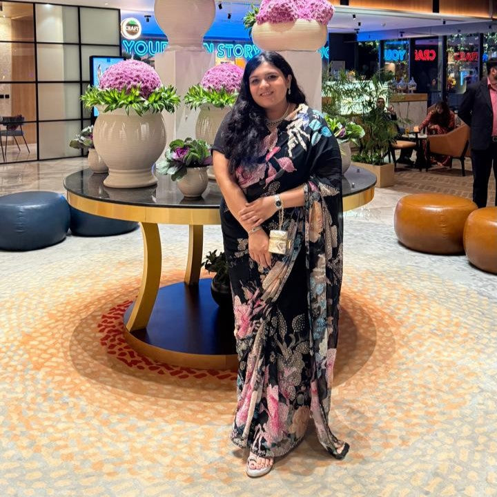 Woman wearing a black floral organza saree